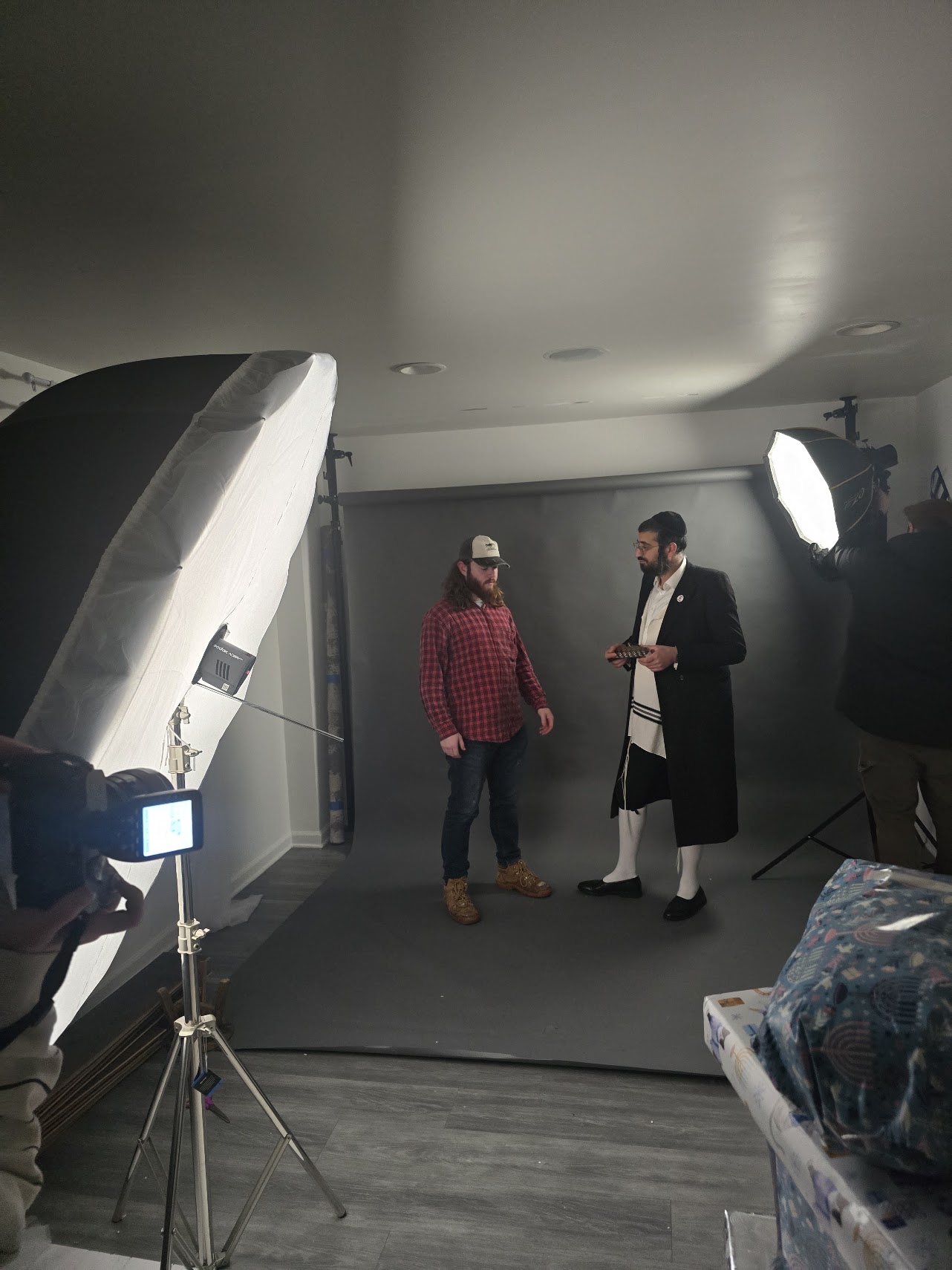 Behind the scenes of the Yehi Ohr Chanukah campaign photoshoot, showing the studio lighting setup.